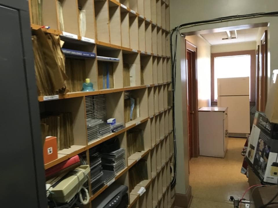 Hallway lined with record and tape storage shelves