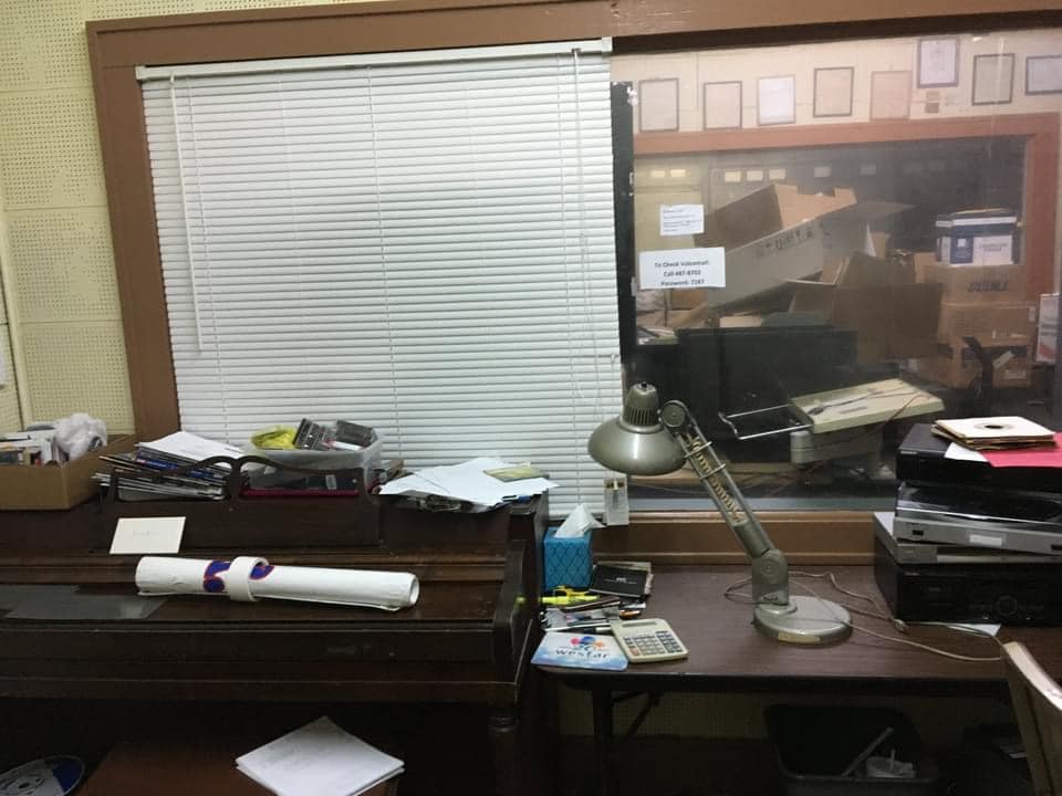 Desk and window looking into a radio studio