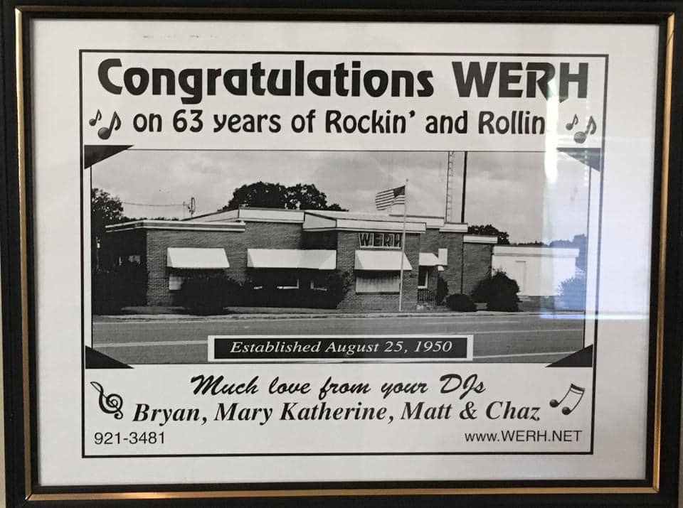Framed WERH anniversary display celebrating 63 years and showing the station building