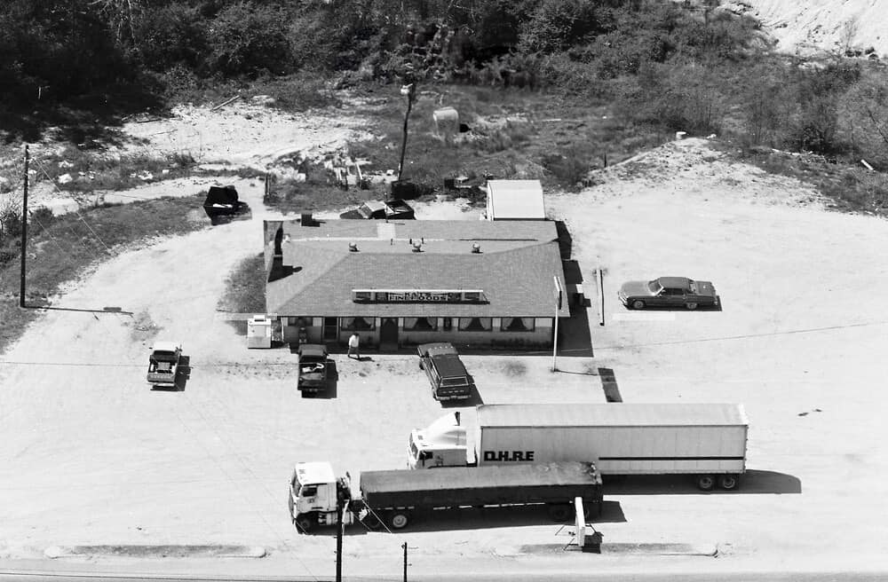 Aerial view of Kat’s Fine Foods with tractor-trailer trucks parked in front