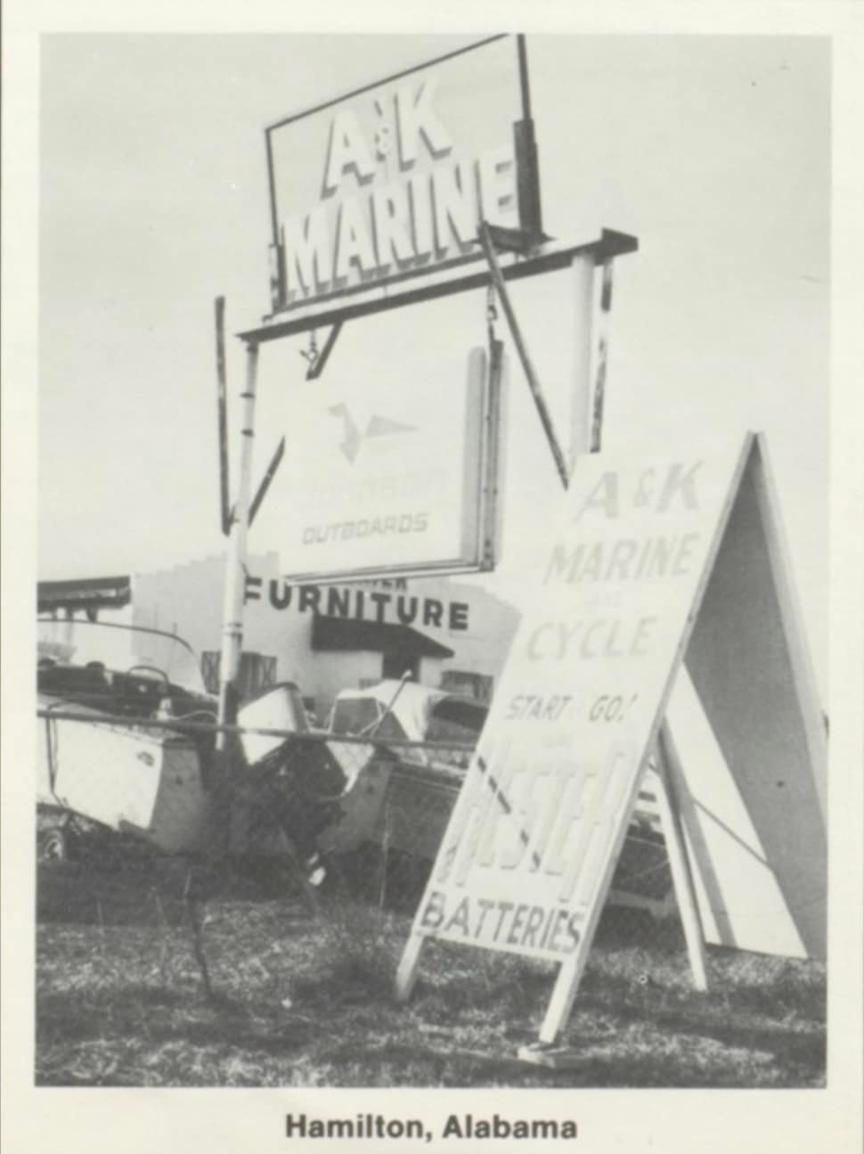 A&K Marine sign above a boat and outboard motors